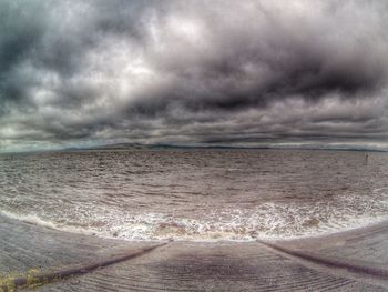 View of calm sea against cloudy sky