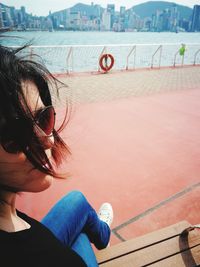 Woman sitting by swimming pool