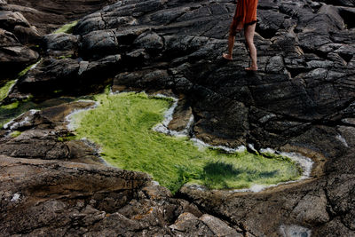 Low section of woman walking on rock formation