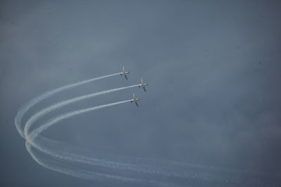 Low angle view of airshow against sky