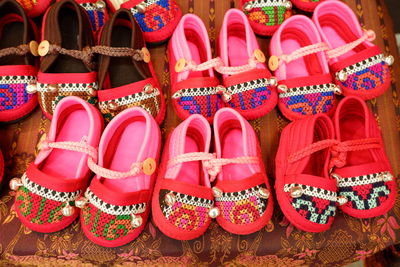 Close-up of multi colored shoes for sale at market stall