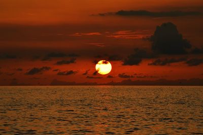 Scenic view of sea against orange sky