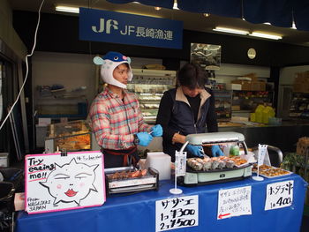 People standing at market stall