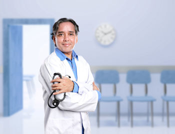 Portrait of female doctor standing in city