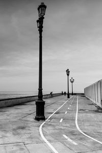 Street light by road against sky