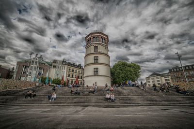 People in town square against sky