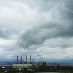 Low angle view of buildings against cloudy sky