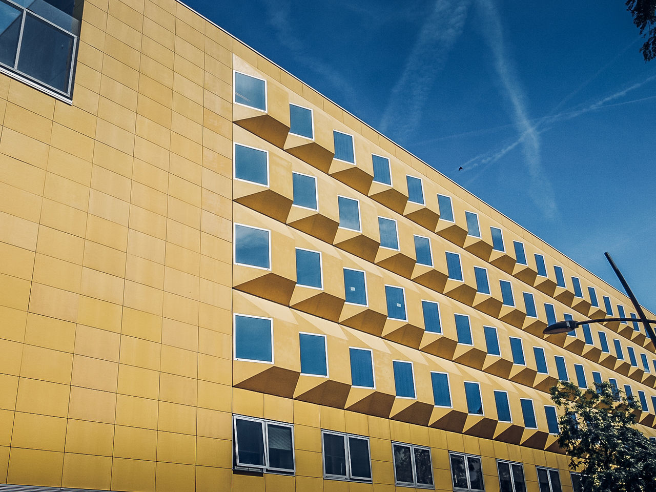 built structure, architecture, building exterior, sky, low angle view, building, window, cloud - sky, nature, sunlight, no people, day, blue, in a row, outdoors, city, pattern, modern, yellow, repetition, office building exterior