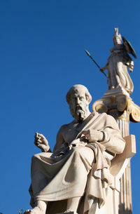 Low angle view of statue against clear blue sky