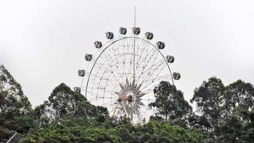 Low angle view of ferris wheel against sky