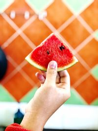 Close-up of hand holding strawberry