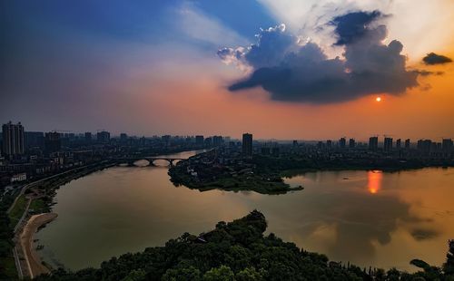 View of city at waterfront during sunset