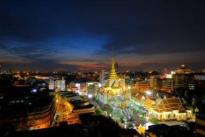 High angle view of city lit up at night