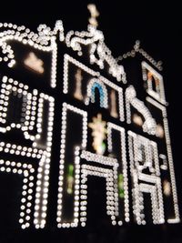 Low angle view of illuminated building at night