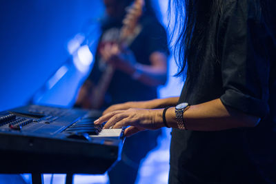 Midsection of woman playing guitar