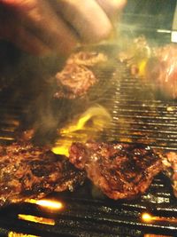 Close-up of meat on barbecue grill