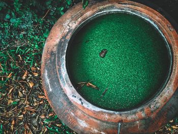 High angle view of old rusty container on field