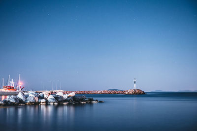 Scenic view of sea against clear blue sky at night