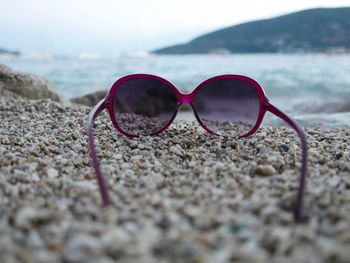 Close-up of sunglasses on beach