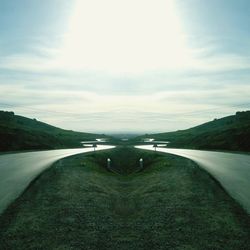 Road passing through landscape against sky