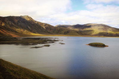 Scenic view of lake against cloudy sky