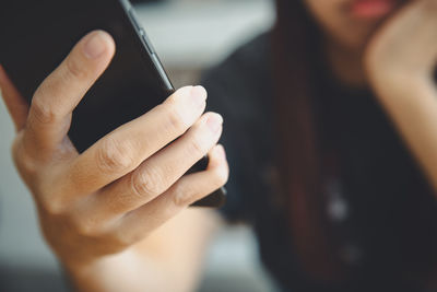 Midsection of woman using mobile phone