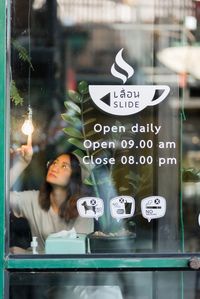 Portrait of young woman standing in cafe