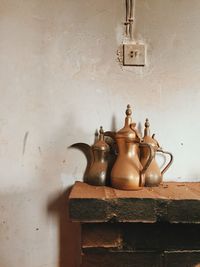 Containers on fireplace against wall