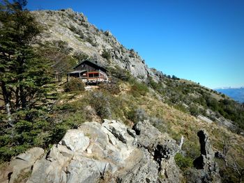 Scenic view of house and mountains against clear sky