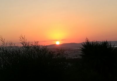 Silhouette landscape against sky during sunset