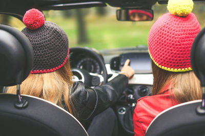 Girls sitting in the car. teen in front of the steering wheel with friend . women enjoying free time