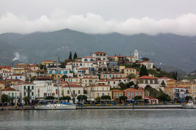 Town by sea against sky in city