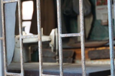 Close-up of rusty metal window on old building