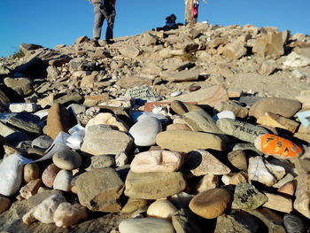 Pebbles on rocks against clear sky