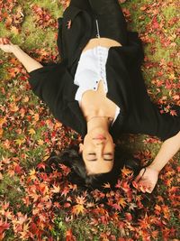 Low section of woman sitting on field