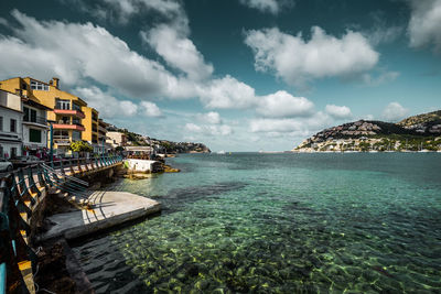 Scenic view of port d'andratx against cloudy sky