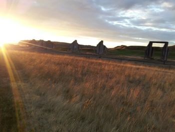 Scenic view of field against sky at sunset