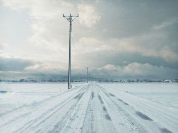 Snow covered landscape against sky