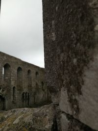 Close-up of old ruin against sky