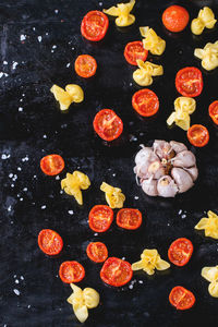 Directly above shot of sacchettini pasta with garlic and sun dried tomatoes on baking sheet