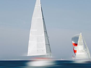 Sailboat on sea against sky