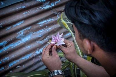 Portrait of man holding red flower