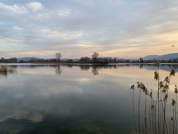 Scenic view of lake against sky during sunset