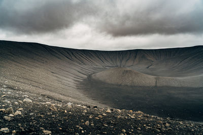 Scenic view of volcanic crater against cloudy sky