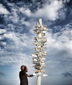 Low angle view of man with text against sky