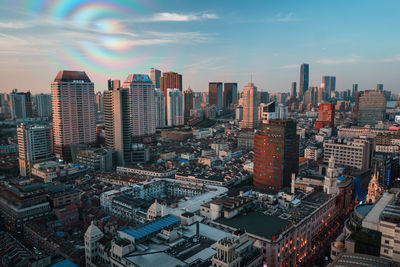 High angle view of modern buildings in city against sky