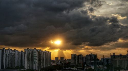 City skyline against cloudy sky