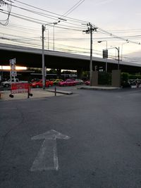 Road leading towards city against sky