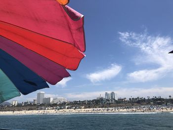 Scenic view of sea by buildings against sky