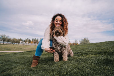 Portrait of happy young woman on field